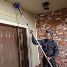 A person removing unwanted pests from a house