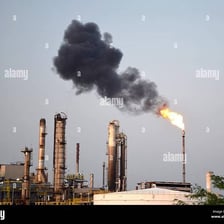 Dark soot residue around an industrial smokestack