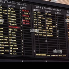 An airport departures board listing flight times
