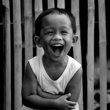 A person smiling and laughing softly.