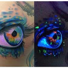 A tattoo fluoresces under ultraviolet light.