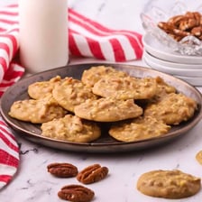 Pecan praline candies arranged on a plate.