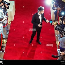 A prominent celebrity arriving at a red-carpet event.