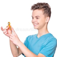 A child holding a very small object between their fingers