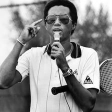 Arthur Ashe holding a tennis racket