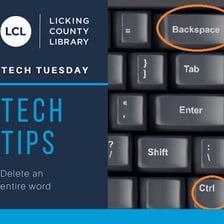A hand presses the Backspace key on a computer keyboard.
