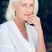 An older person with noticeably gray-white hair.