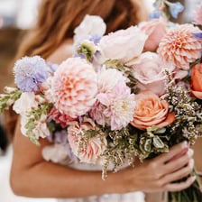 A person courting a romantic partner with flowers.