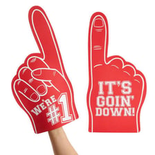 An oversized foam hand held by a sports fan