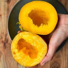 A sliced mango with its large central pit visible