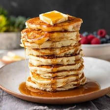 A stack of hotcakes topped with syrup