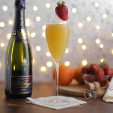 Two glasses of orange-colored mimosas at brunch