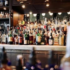 Several alcoholic beverages arranged on a bar