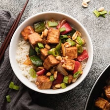 A serving of kung pao tofu with vegetables and peanuts.