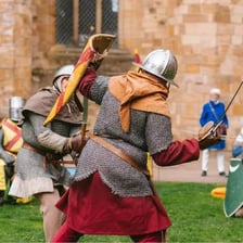 Two opponents facing each other in a historical sword duel.