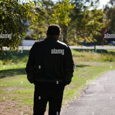 A person walking back along a path