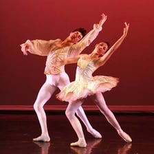 Two ballet dancers performing a pas de deux.