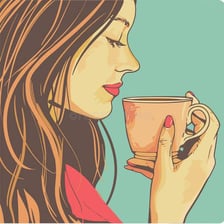 A person taking a small, delicate sip of tea