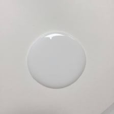 A small gooey lump of adhesive on a surface
