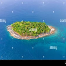 A tiny, uninhabited island surrounded by clear water.