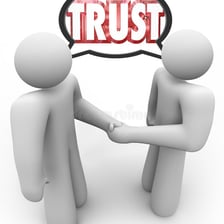 Two people shaking hands in a gesture of trust