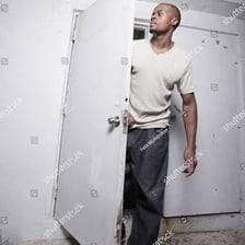 A person leaving through a doorway