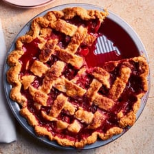 A baked fruit pie served on a plate.