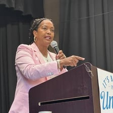 A labor union representative addressing a group of workers
