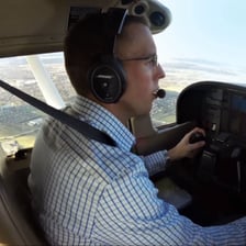 A pilot using a radio headset during communication.