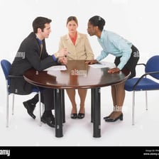 A group of people signaling agreement during a meeting.