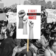 People standing in a picket line holding protest signs