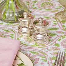 Matching salt and pepper shakers placed together on a dining table.