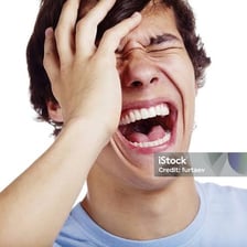 A person caught in a broad, loud laugh.