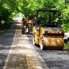 Workers paving a road, illustrating the phrase “pave the way”