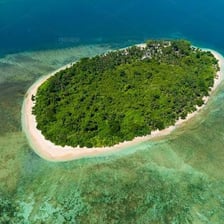A small island surrounded by blue water