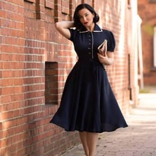 A woman wearing a vintage-style tea dress.