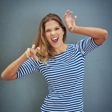 A person making a playful, mock-growling facial expression.