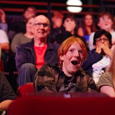 A family watching an age-appropriate movie together.