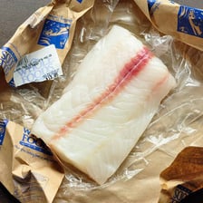 A boneless fillet shown beside a fish skeleton.