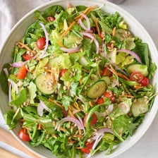 A bowl of fresh leafy salad greens.