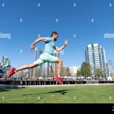 An energetic person running outdoors.