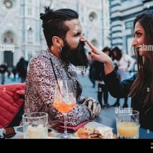 A person playfully touching another person’s nose