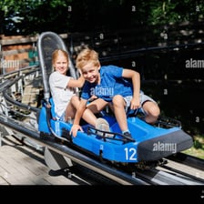 A delighted child laughing while riding an amusement-park attraction.