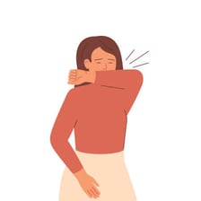 A person sneezing into their elbow.