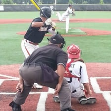 A baseball umpire standing behind home plate