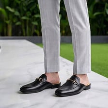 A person wearing backless mule shoes.