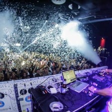A DJ performing electronic dance music in a club