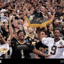 New Orleans Saints fans cheering in a stadium