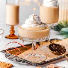 Glasses of creamy eggnog garnished with nutmeg.