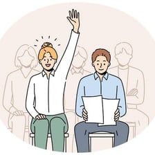 A person raising a hand to volunteer